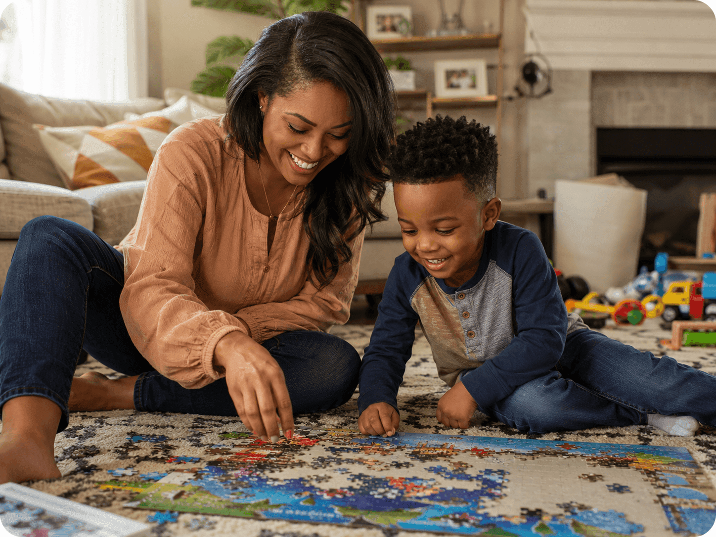 A mother and her young son working on a jigsaw puzzle together at home